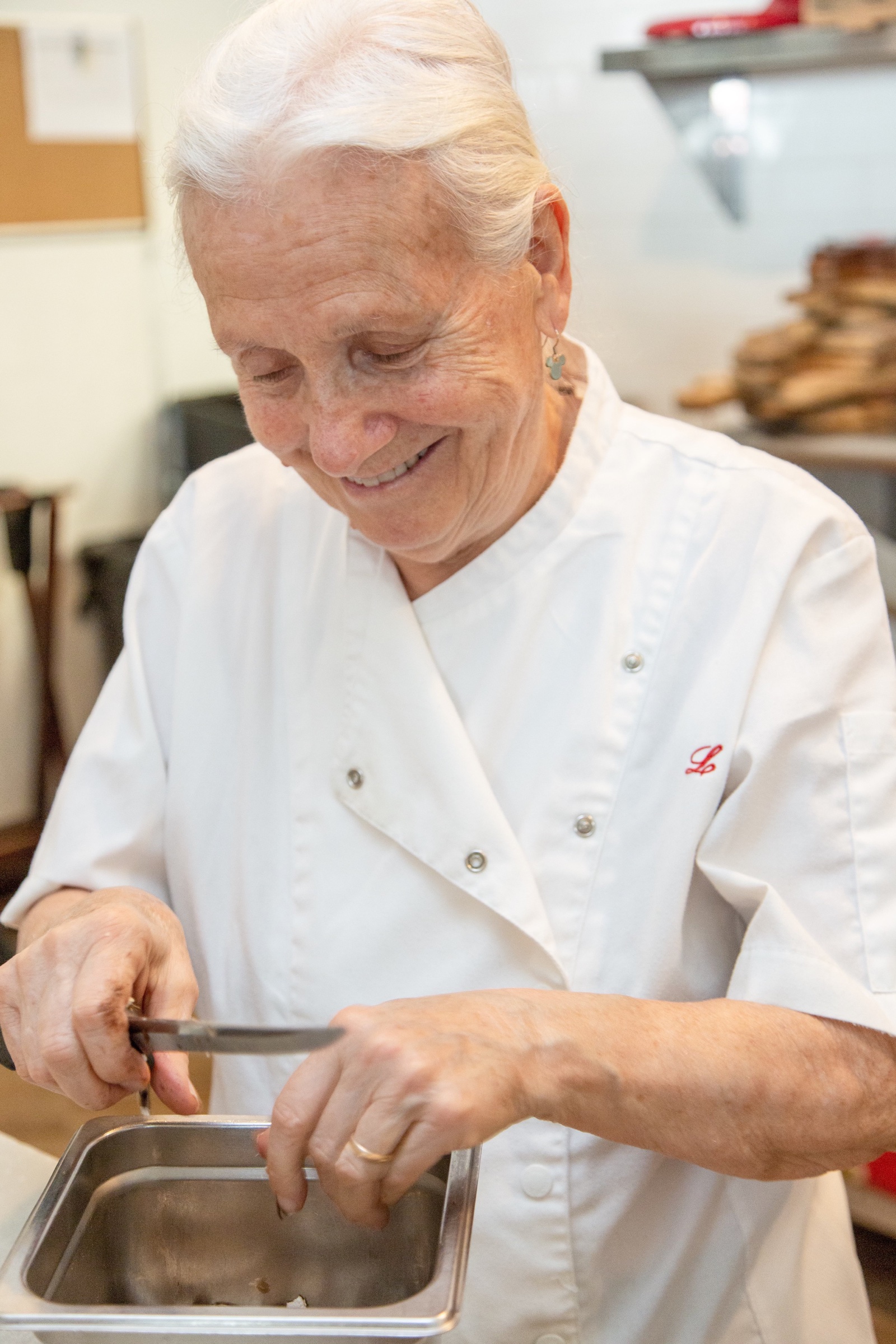 Molto's chef, smiling, preparing food in the kitchen